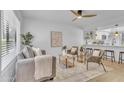 Bright living room with neutral tones, modern decor, and an open layout connecting to the kitchen at 15435 N 28Th St # 3, Phoenix, AZ 85032