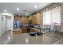 Well-appointed kitchen showcases granite countertops, a stylish backsplash, and modern stainless steel appliances at 17541 W Statler Dr, Surprise, AZ 85388