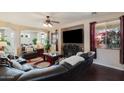 Comfortable living room with a large TV, a ceiling fan, and a nice view of the yard at 17541 W Statler Dr, Surprise, AZ 85388