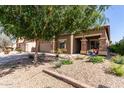 Charming two-story home with a large driveway, desert landscaping, and stone accents on the facade at 17753 W Columbine Dr, Surprise, AZ 85388