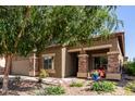 Charming two-story home with a large driveway, desert landscaping, and stone accents on the facade at 17753 W Columbine Dr, Surprise, AZ 85388