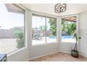 Bright dining area with large windows offering views of the pool and lush backyard landscaping at 2031 W Gila Ln, Chandler, AZ 85224