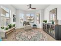 Cozy living room showcasing a comfortable chair, stylish rug, and plenty of natural light streaming through the windows at 21167 E Aspen Valley Dr, Queen Creek, AZ 85142