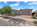 Charming home featuring a three car garage, a brick driveway, and desert landscaping at 21934 E Lords Ct, Queen Creek, AZ 85142