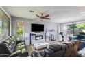 Bright living room with large windows, wood floors, and modern entertainment center at 2275 N Heritage St, Buckeye, AZ 85396