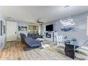 Spacious living room with modern lighting, wood floors, and comfortable seating area at 2275 N Heritage St, Buckeye, AZ 85396