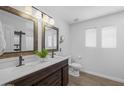 Well-lit bathroom with a double sink vanity, elegant mirrors, a separate toilet area, and modern fixtures for added convenience at 2661 E Los Alamos Ct, Gilbert, AZ 85295