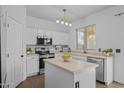 Bright kitchen featuring white cabinetry, modern appliances, an island with ample counter space, and natural light from the window at 2661 E Los Alamos Ct, Gilbert, AZ 85295