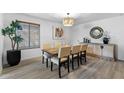 Well-lit dining room with table, six chairs, and a stylish sideboard with decorative mirror at 2804 N Nebraska St, Chandler, AZ 85225