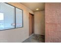 A close-up view of the unit entrance with a window and security camera signs at 3810 N Maryvale Pkwy # 1059, Phoenix, AZ 85031