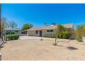 Charming single-story home with a well-manicured front yard, xeriscape, and inviting curb appeal at 3822 W Flower St, Phoenix, AZ 85019