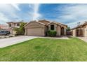 Inviting single-story house with a lush green lawn and an expansive driveway at 3856 E Encinas Ave, Gilbert, AZ 85234