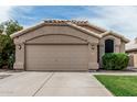 Close-up of a two-car garage with neutral paint and decorative tile roofing detail at 3856 E Encinas Ave, Gilbert, AZ 85234