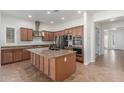 Spacious kitchen features stainless steel appliances, granite countertops, and a central island with a sink at 3886 E Ficus Way, Gilbert, AZ 85298