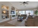 Comfortable living room featuring built-in shelving and a ceiling fan at 3925 N 160Th Ave, Goodyear, AZ 85395