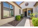 Inviting front entrance with a covered walkway, desert landscaping, and a stylish front door at 3971 E Leo Pl, Chandler, AZ 85249