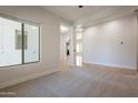 Open-concept living space with neutral carpet, offering seamless flow and ample natural light at 3971 E Leo Pl, Chandler, AZ 85249