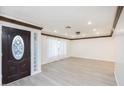 Large living area with new floors, modern trim, and a decorative glass front door at 4628 W Solano S Dr, Glendale, AZ 85301