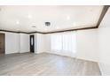 Bright living room featuring new floors, updated lighting, and modern trim at 4628 W Solano S Dr, Glendale, AZ 85301