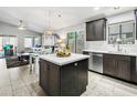 Open kitchen with modern appliances, island, and adjacent living area, perfect for entertaining at 4704 E Melinda Ln, Phoenix, AZ 85050