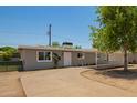 Charming single-story home featuring a well-maintained front yard and a welcoming entrance at 5029 W Osborn Rd, Phoenix, AZ 85031