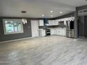Spacious kitchen with sleek stainless steel appliances and modern white cabinets at 5029 W Osborn Rd, Phoenix, AZ 85031