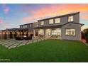 An expansive backyard features a manicured lawn, a cozy fire pit, and outdoor dining areas at 5661 S Dante --, Mesa, AZ 85212