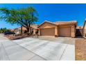Beautiful home featuring a three-car garage, tile roof, and low-maintenance desert landscaping at 5912 W Gail Dr, Chandler, AZ 85226