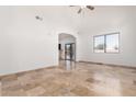 Open living space with travertine flooring, arched entryway, and lots of light at 6320 S 26Th Dr, Phoenix, AZ 85041