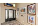 Inviting entryway featuring a stylish front door, artwork, and unique light fixture at 7673 N Via De Platina Dr, Scottsdale, AZ 85258