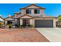 Charming two-story home with a well-manicured front yard, and a two car garage at 7749 W Hearn Rd, Peoria, AZ 85381