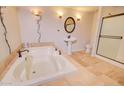 Well-lit bathroom with a soaking tub, pedestal sink, and shower stall at 809 N Gilbert Ave, Casa Grande, AZ 85122