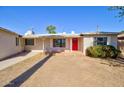 Charming single-story home with a vibrant red front door and well-maintained yard at 809 N Gilbert Ave, Casa Grande, AZ 85122