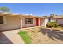 Charming single-story home with a red front door and well-maintained front yard at 809 N Gilbert Ave, Casa Grande, AZ 85122