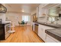 Traditional-style kitchen with hardwood floors and stainless steel appliances adjacent to dining area at 809 N Gilbert Ave, Casa Grande, AZ 85122