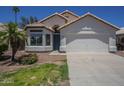 Charming single-Gathering home with a two-car garage and well-maintained front yard at 8370 W Audrey Ln, Peoria, AZ 85382