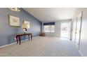 Bright living room with a blue accent wall, comfortable seating, and plenty of natural light at 884 W 15Th Ave, Apache Junction, AZ 85120