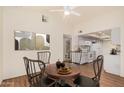 Cozy dining area adjacent to the kitchen, featuring a round table and a view of the bathroom at 927 E Charleston Ave, Phoenix, AZ 85022