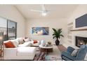 Bright living room with a fireplace, modern decor, a ceiling fan and a comfortable seating area at 927 E Charleston Ave, Phoenix, AZ 85022