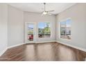 Bright living room with wood floors, ceiling fan, and a balcony perfect for relaxation at 945 E Playa Del Norte Dr # 3009, Tempe, AZ 85288