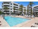 Resort-style pool area with lounge chairs and a cozy fireplace, perfect for relaxation at 945 E Playa Del Norte Dr # 3009, Tempe, AZ 85288