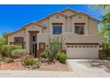Two-story home boasts desert landscaping, a neutral color palette, and a three-car garage at 9661 E Glencove Cir, Mesa, AZ 85207