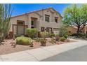 Two-story home boasts desert landscaping, a neutral color palette, and a three-car garage at 9661 E Glencove Cir, Mesa, AZ 85207