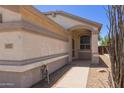 Charming single-story home featuring desert landscaping and a welcoming arched entrance at 9717 W Purdue Ave, Peoria, AZ 85345