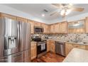 An updated kitchen features stainless steel appliances and wooden cabinets at 9801 N 56Th Dr, Glendale, AZ 85302