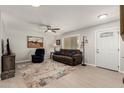 Cozy living room featuring a comfortable sofa, area rug, and plenty of natural light at 10702 W Salem Dr, Sun City, AZ 85351