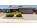Charming single story home features desert landscaping and a spacious two-car garage at 11523 E Lindner Ave, Mesa, AZ 85209