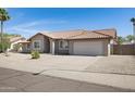 Single-story home featuring a desert landscape, neutral exterior, and tile roof at 1231 E Sunburst Ln, Tempe, AZ 85284