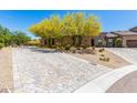A stunning home featuring a paved driveway and desert landscaping at 12325 S 179Th Ave # 29, Goodyear, AZ 85338