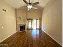 Spacious living room features a fireplace, hardwood floors, high ceilings, and sliding glass doors to the patio at 1309 W Calle Del Norte --, Chandler, AZ 85224